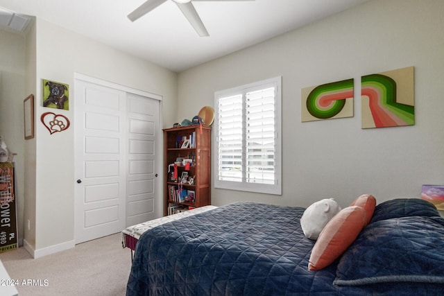 carpeted bedroom with multiple windows, a closet, and ceiling fan