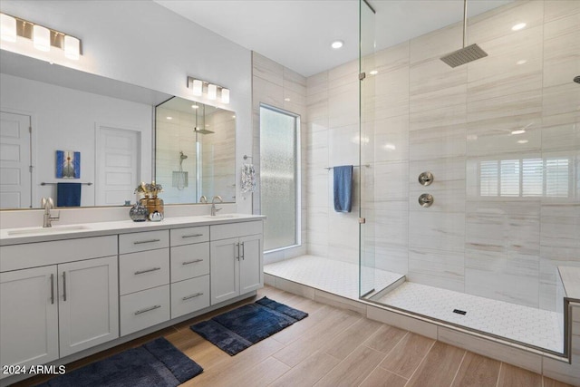 bathroom featuring vanity and tiled shower