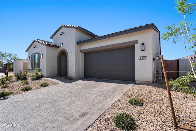 mediterranean / spanish home featuring a garage