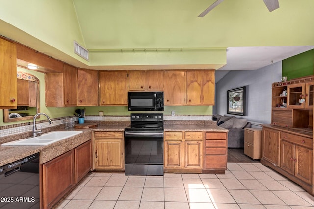 kitchen featuring black appliances, a sink, light tile patterned floors, brown cabinets, and high vaulted ceiling