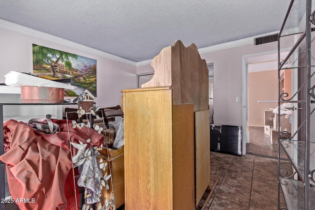 interior space featuring ornamental molding and a textured ceiling