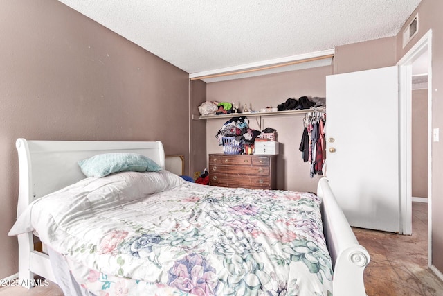 bedroom with a closet and a textured ceiling