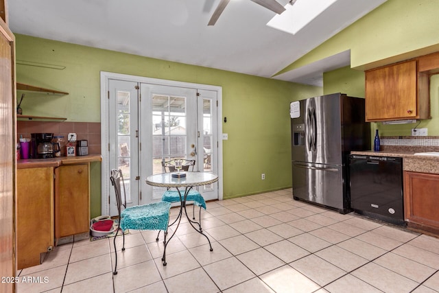 kitchen featuring black dishwasher, stainless steel fridge, a ceiling fan, vaulted ceiling, and brown cabinets