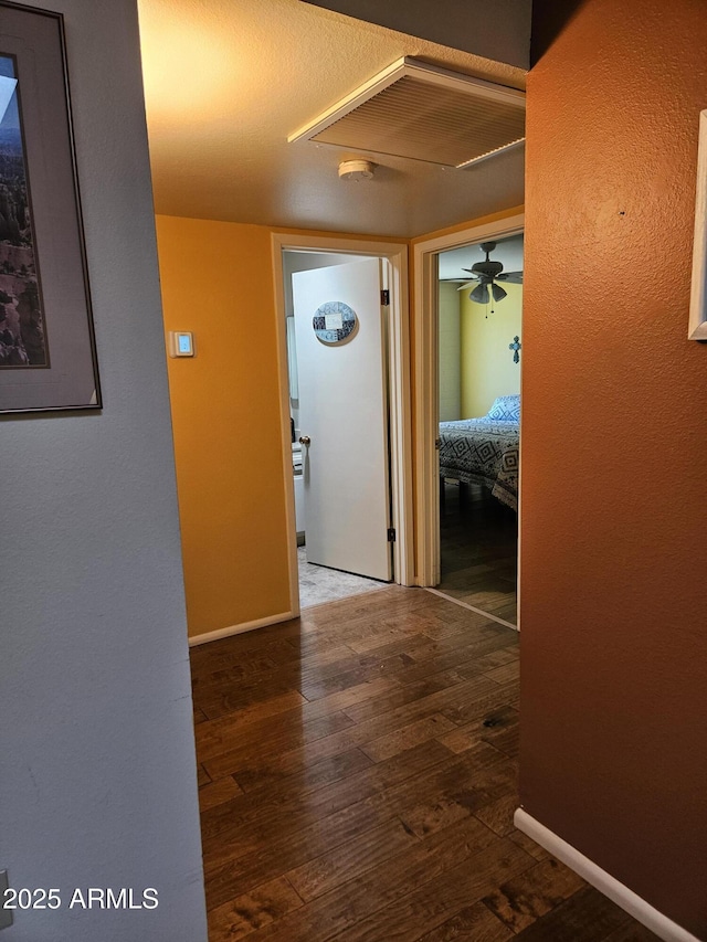 hall with hardwood / wood-style floors and baseboards