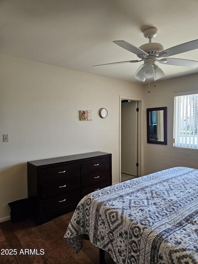 bedroom with ceiling fan and dark wood-style floors