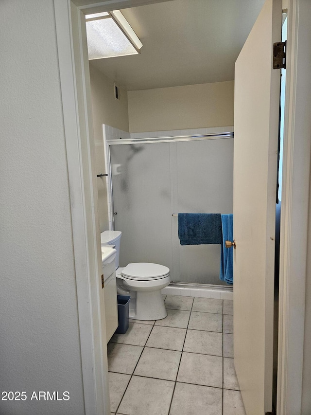 full bathroom with tile patterned flooring, a shower stall, toilet, vanity, and visible vents