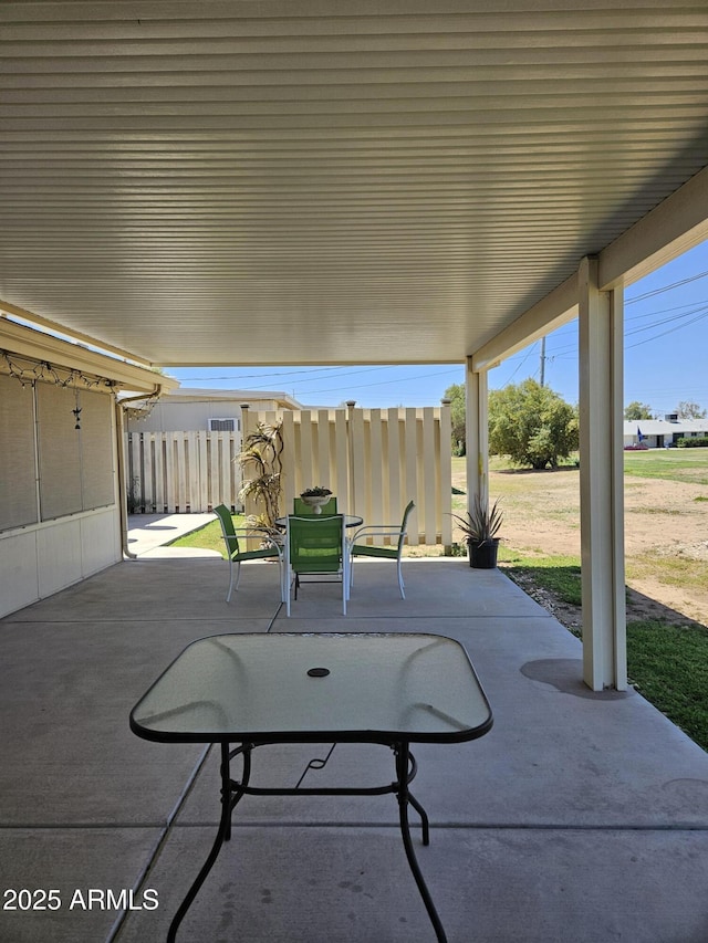 view of patio / terrace featuring fence and outdoor dining space