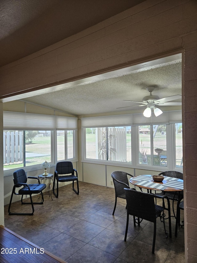 sunroom / solarium featuring a textured ceiling