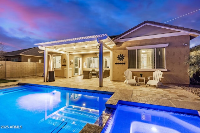 pool at dusk with an outdoor hangout area, a pergola, and a patio area