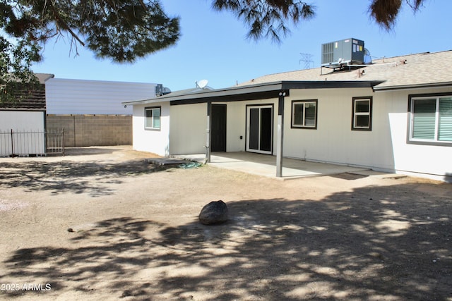 back of house featuring fence, cooling unit, and a patio