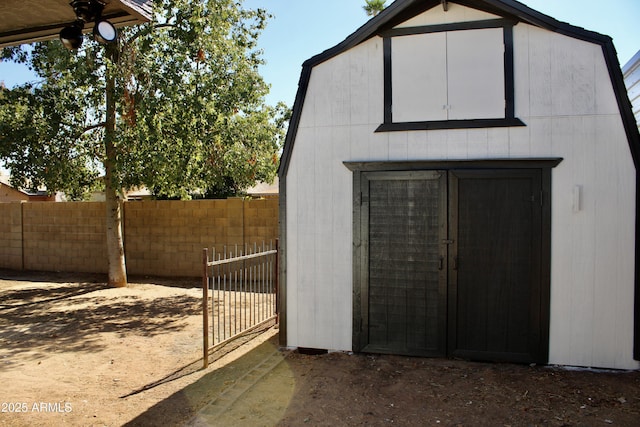 view of shed featuring fence