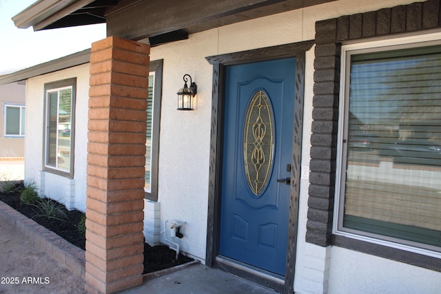 doorway to property with stucco siding