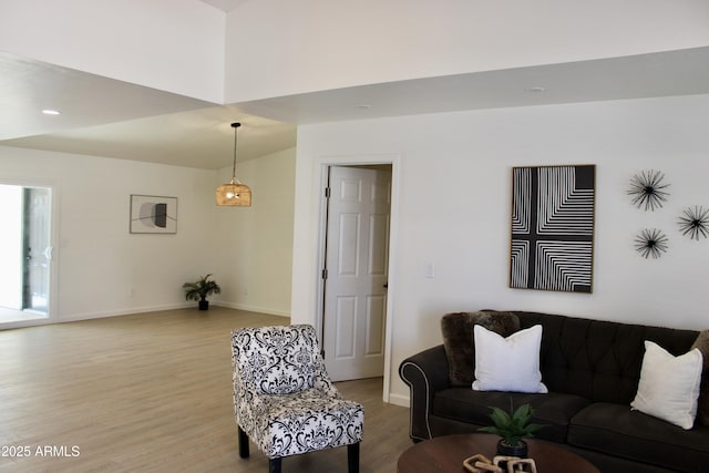 living area featuring baseboards, wood finished floors, and recessed lighting