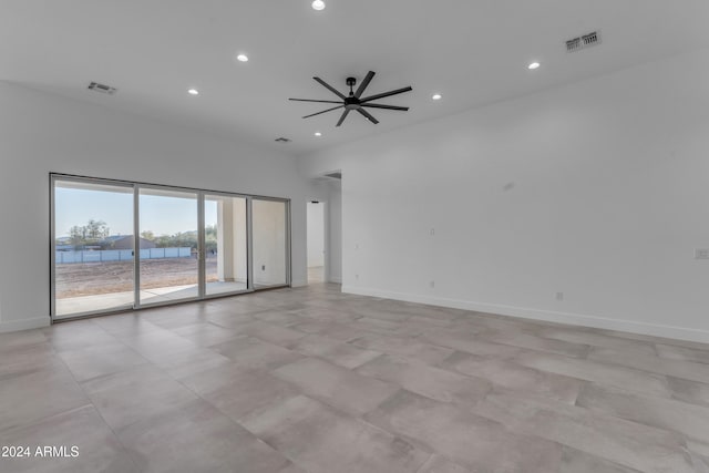 unfurnished room featuring ceiling fan and a water view