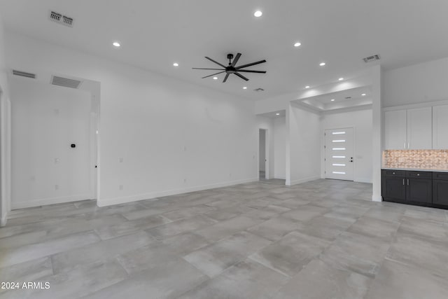 unfurnished living room with ceiling fan