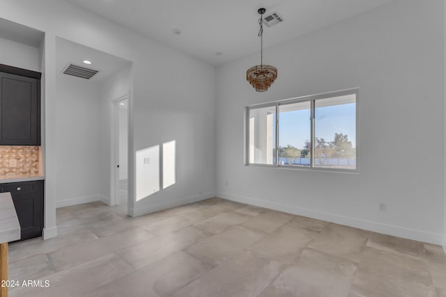 unfurnished dining area with light tile patterned flooring