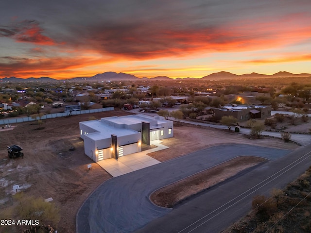 aerial view at dusk featuring a mountain view