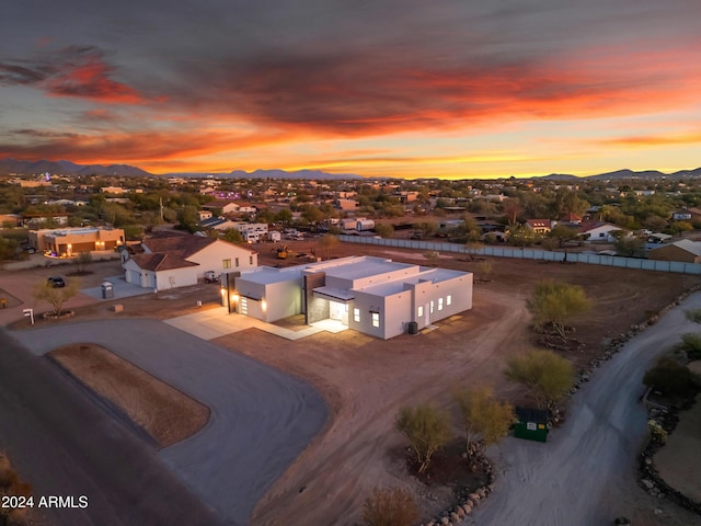 aerial view at dusk featuring a mountain view