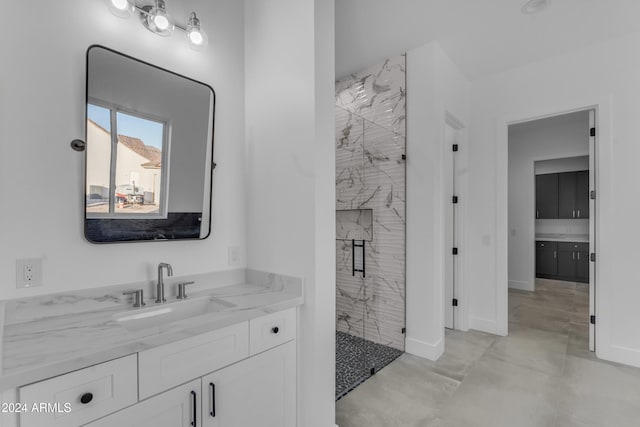 bathroom featuring vanity and an enclosed shower