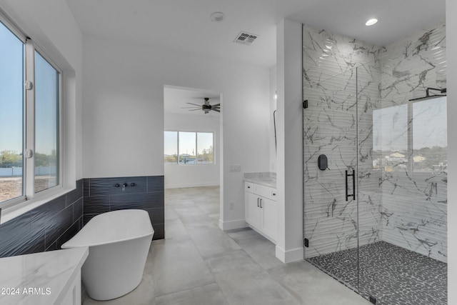 bathroom featuring vanity, separate shower and tub, plenty of natural light, and ceiling fan