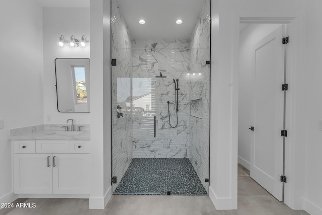 bathroom with vanity and a shower with door