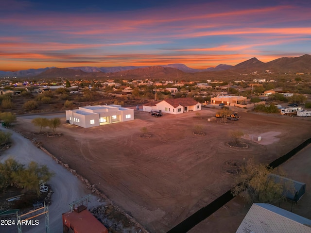 aerial view at dusk featuring a mountain view