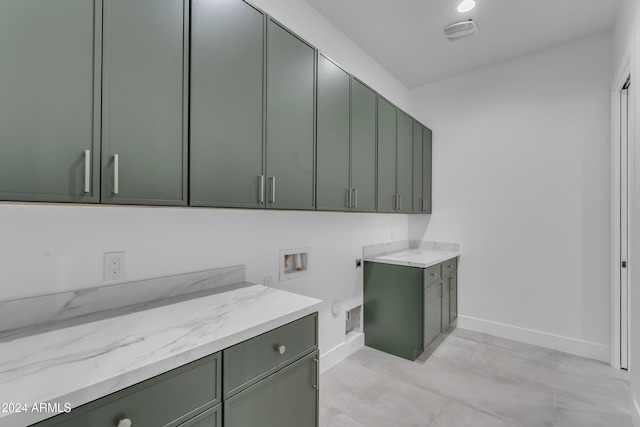 laundry area with hookup for an electric dryer, cabinets, and hookup for a washing machine