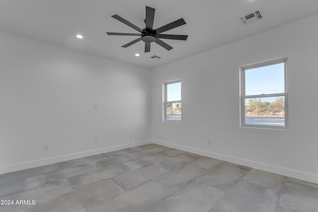 spare room featuring plenty of natural light and ceiling fan