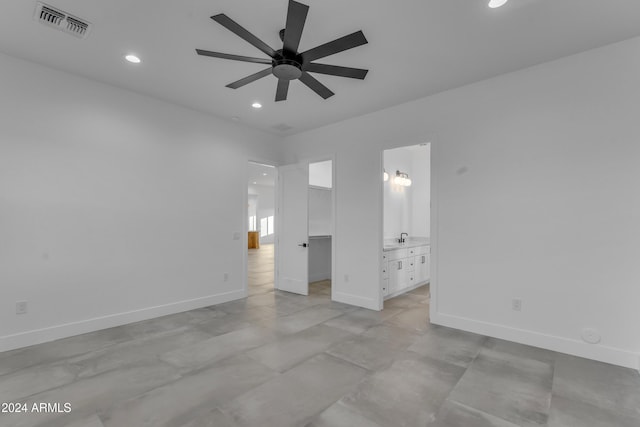 unfurnished bedroom featuring ensuite bathroom and ceiling fan