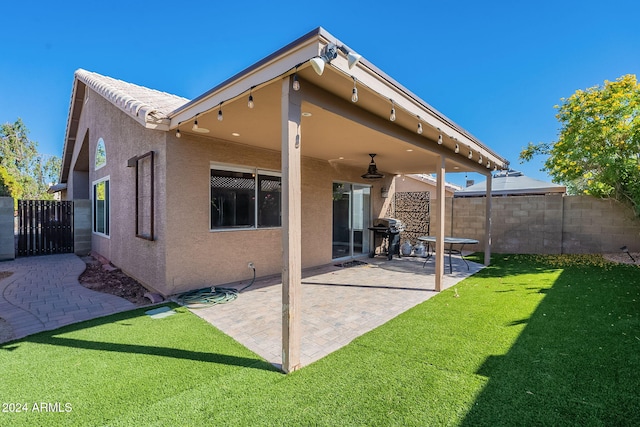 rear view of house featuring a patio and a lawn