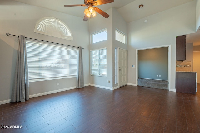 unfurnished room featuring high vaulted ceiling, dark wood-type flooring, and ceiling fan