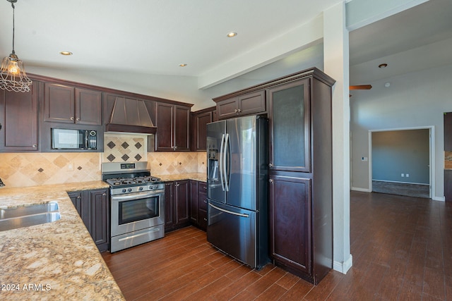 kitchen featuring pendant lighting, premium range hood, stainless steel appliances, and dark hardwood / wood-style flooring