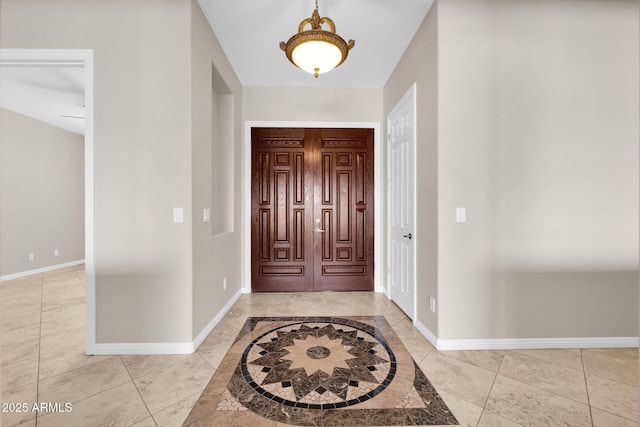 foyer entrance with light tile patterned floors