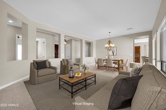 living room with an inviting chandelier and carpet flooring