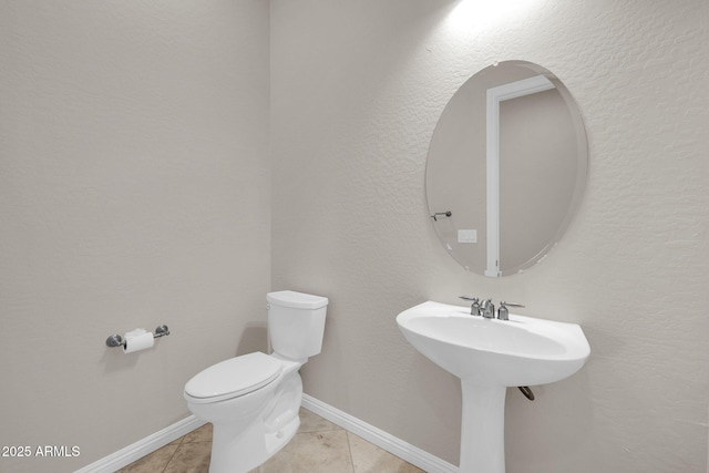 bathroom featuring sink, tile patterned floors, and toilet