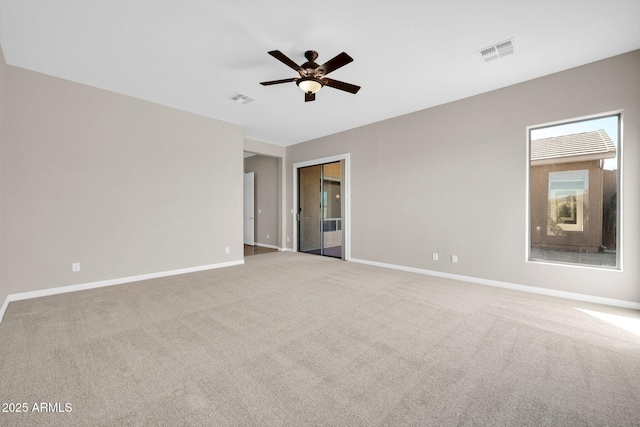 carpeted spare room featuring ceiling fan