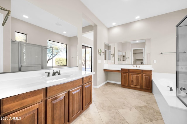 bathroom featuring shower with separate bathtub, vanity, and tile patterned floors