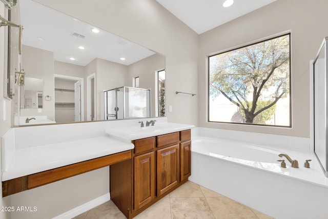 bathroom featuring independent shower and bath, vanity, and tile patterned floors