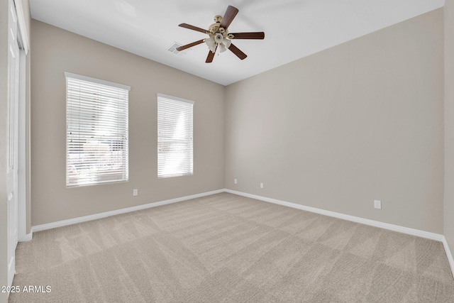 unfurnished room featuring light carpet and ceiling fan