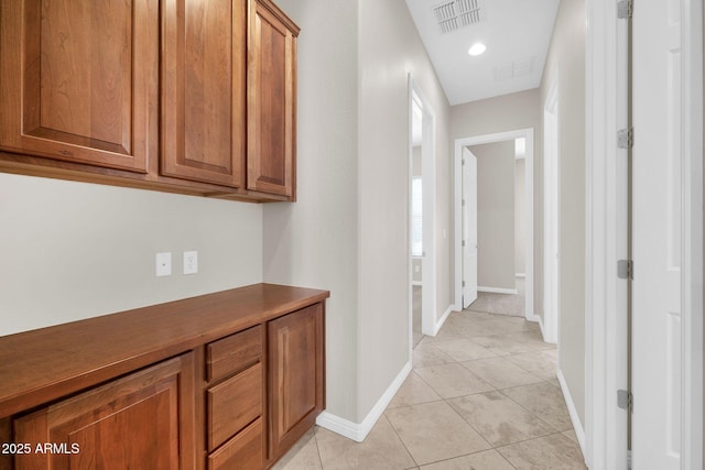 hall with light tile patterned floors