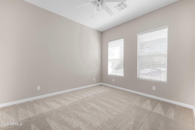 carpeted spare room featuring ceiling fan