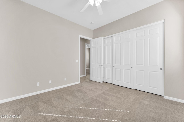 unfurnished bedroom with ceiling fan, light colored carpet, and a closet