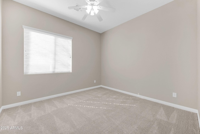 carpeted empty room featuring ceiling fan