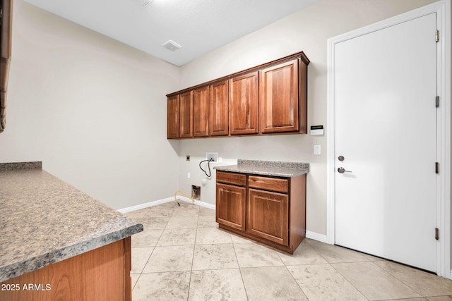 clothes washing area with cabinets, washer hookup, hookup for an electric dryer, and light tile patterned floors