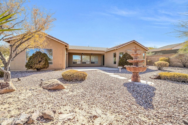 ranch-style home with ceiling fan and a patio area