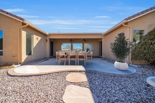 exterior space with ceiling fan and a patio area