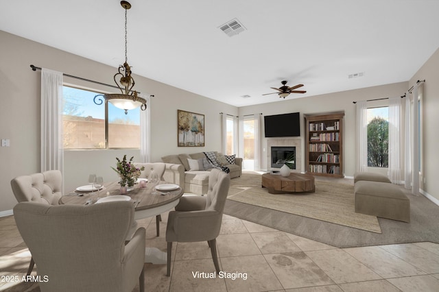 dining area featuring ceiling fan, light tile patterned floors, and a wealth of natural light