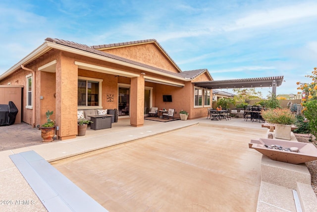 rear view of property featuring a patio and a pergola