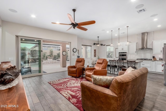 living room featuring ceiling fan and hardwood / wood-style floors