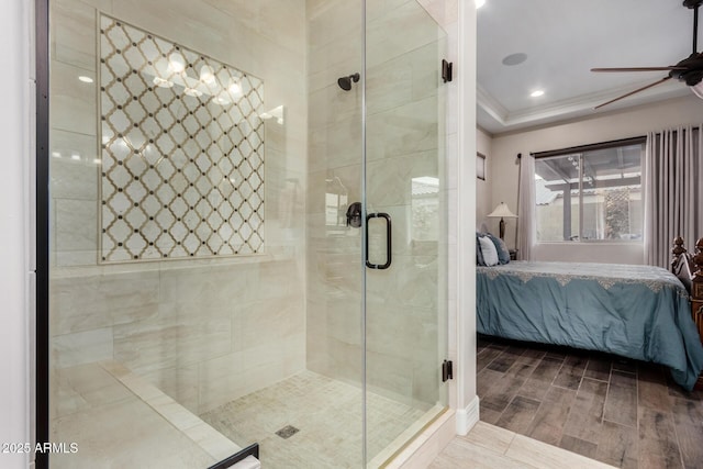 bathroom with walk in shower, ceiling fan, and ornamental molding